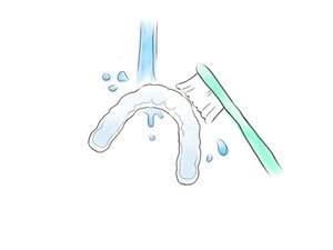 マウスピースを歯ブラシで洗っているイラスト